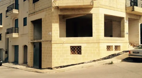 Corner showroom with underlying garage in Paola